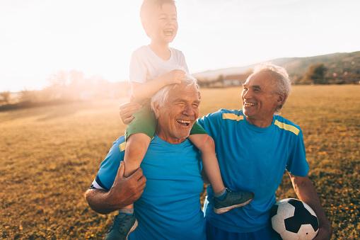 older men, young boy, soccer