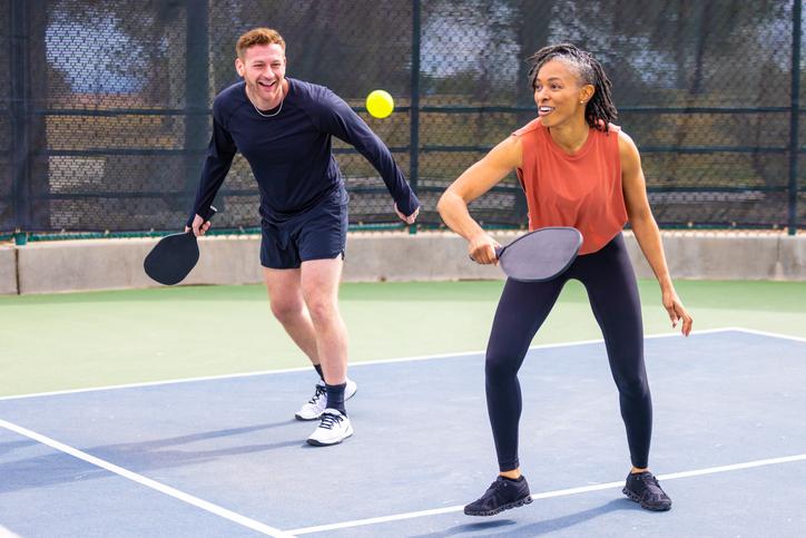 man and woman playing pickleball 