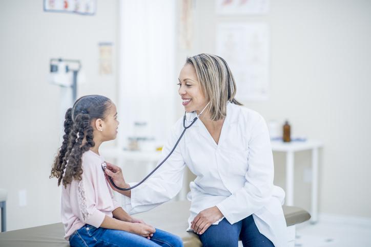 female doctor, young girl patient, doctor's office