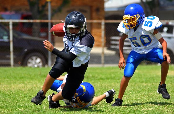 young athletes playing football