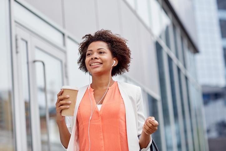 woman walking and holding coffee