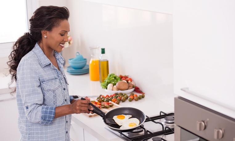 woman cooking eggs