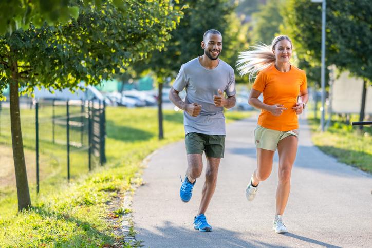 man and woman jogging outside