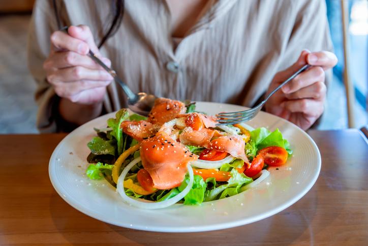 person eating salmon salad