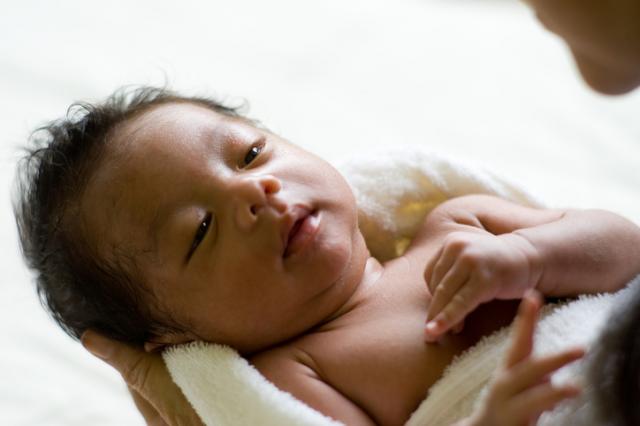 newborn baby being held