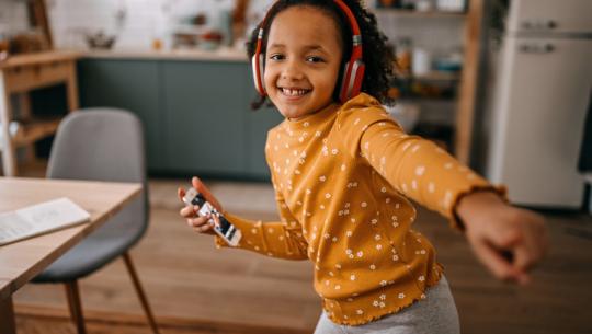 young child dancing to music