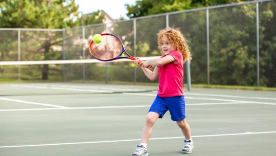 young girl playing tennis