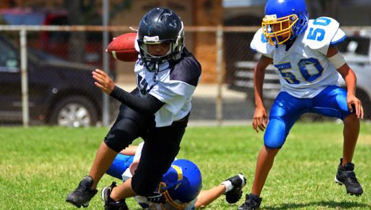 young athletes playing football