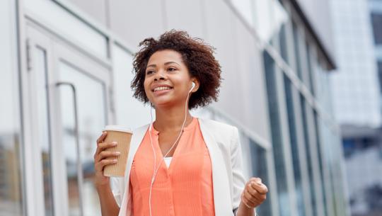 woman walking and holding coffee