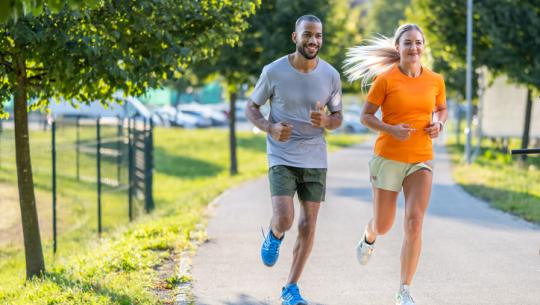 man and woman jogging outside