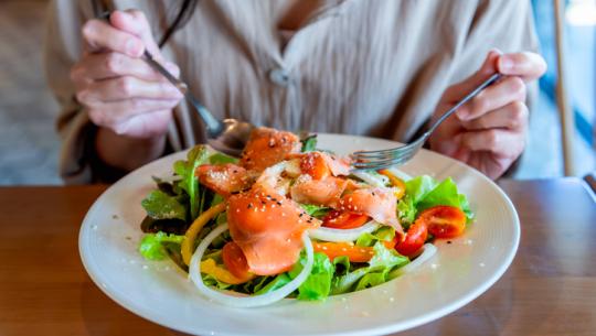 person eating salmon salad