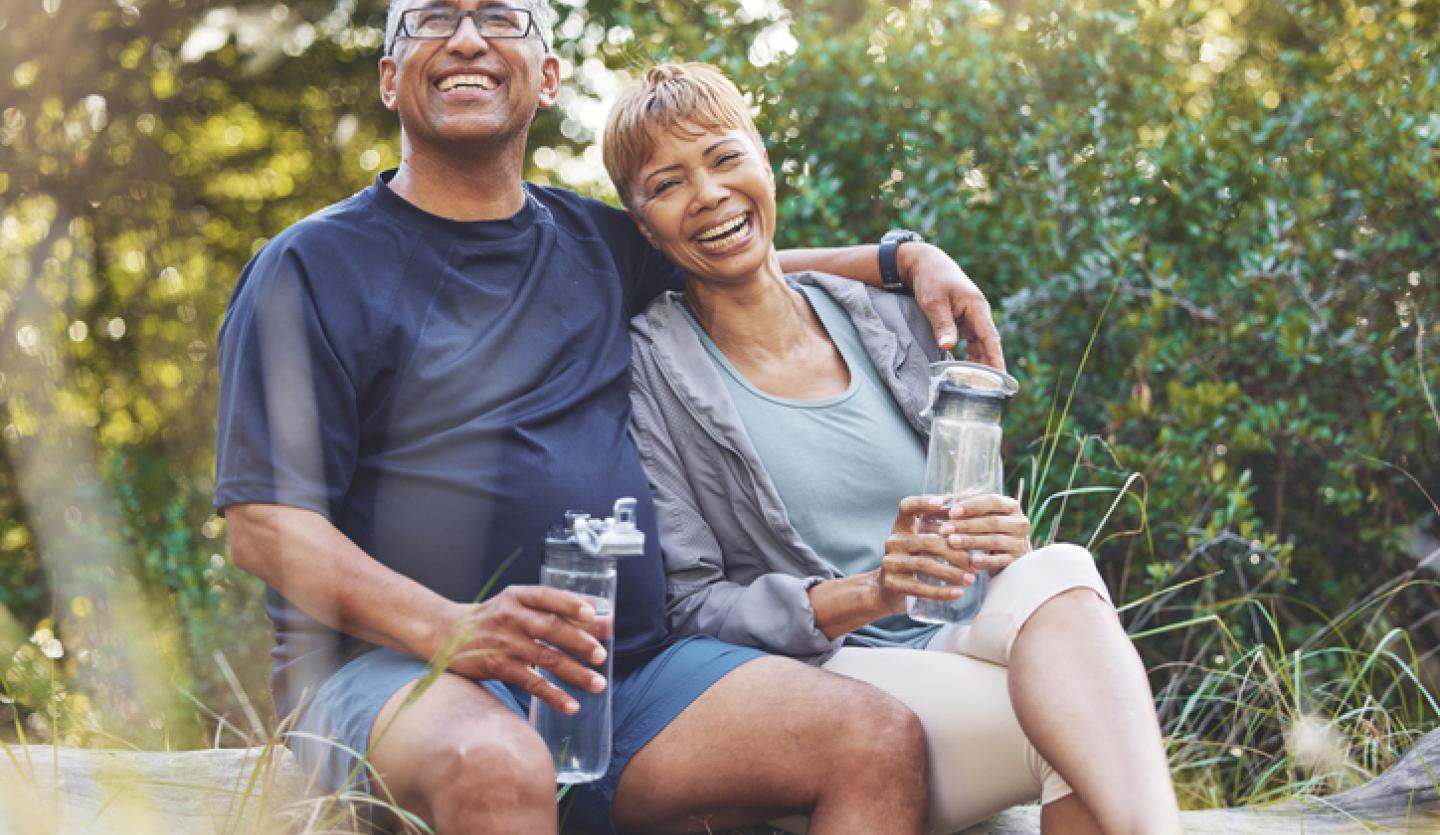 man and woman outside drinking water