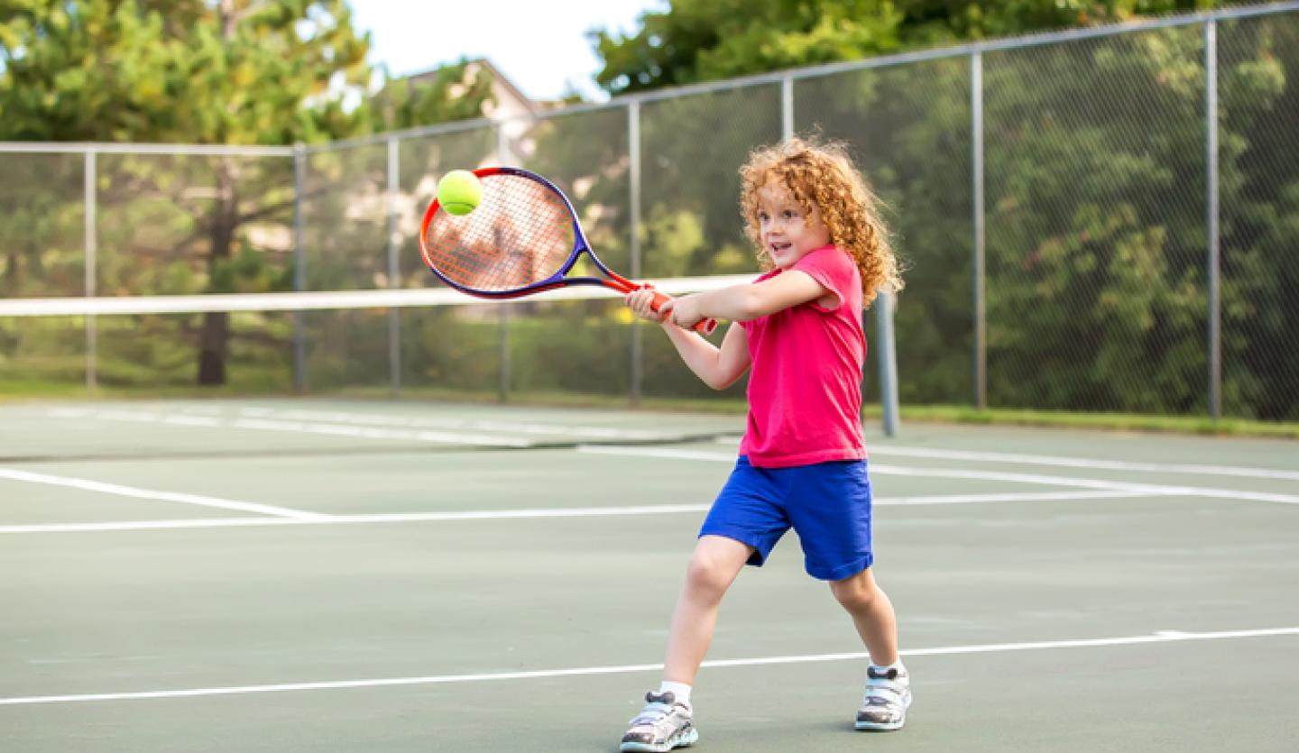 young girl playing tennis