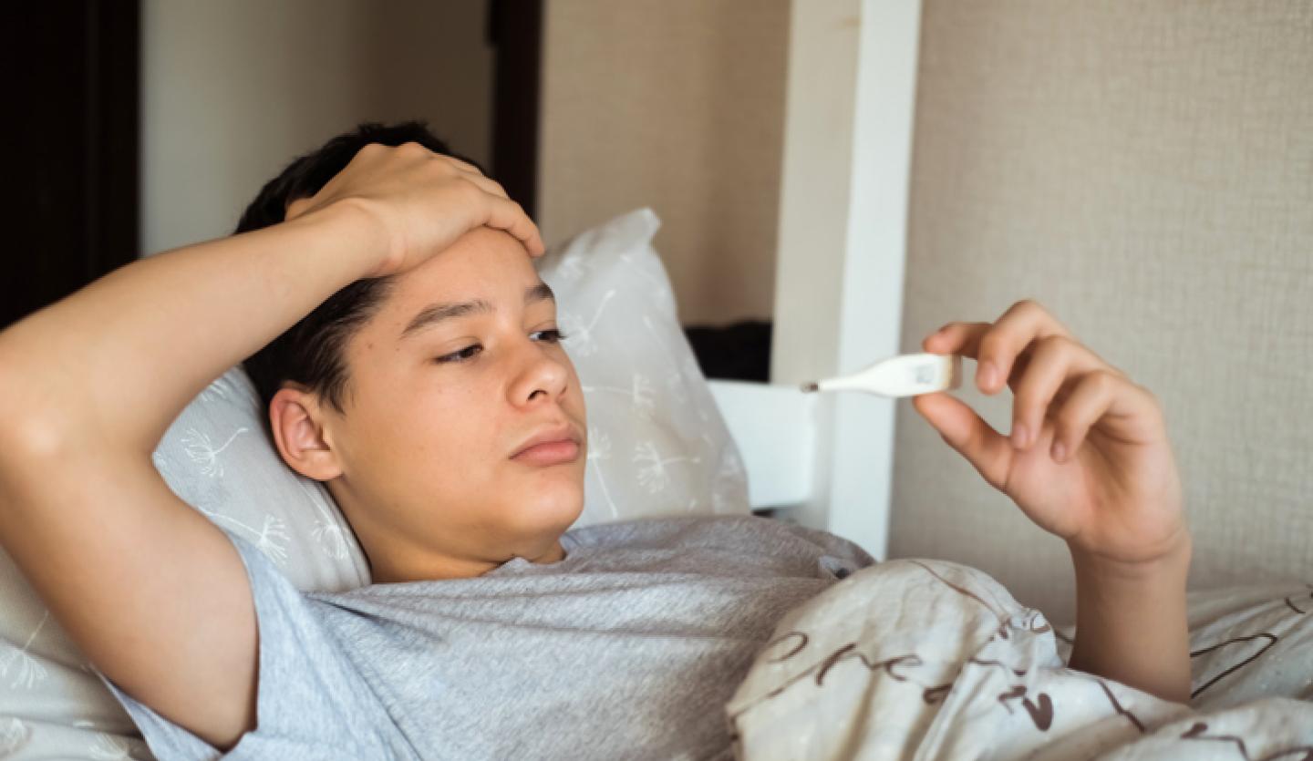 teenager laying down checking temperature