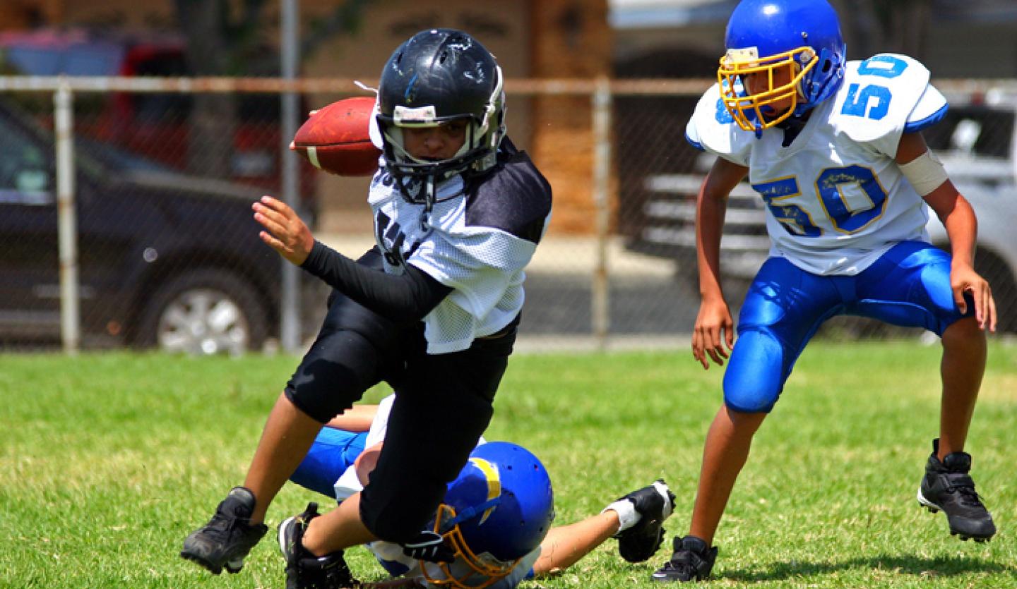 young athletes playing football