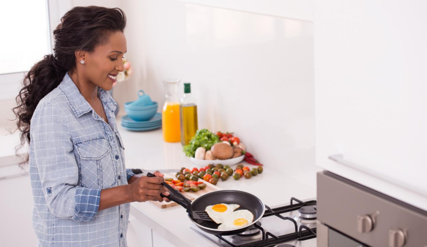 woman cooking eggs