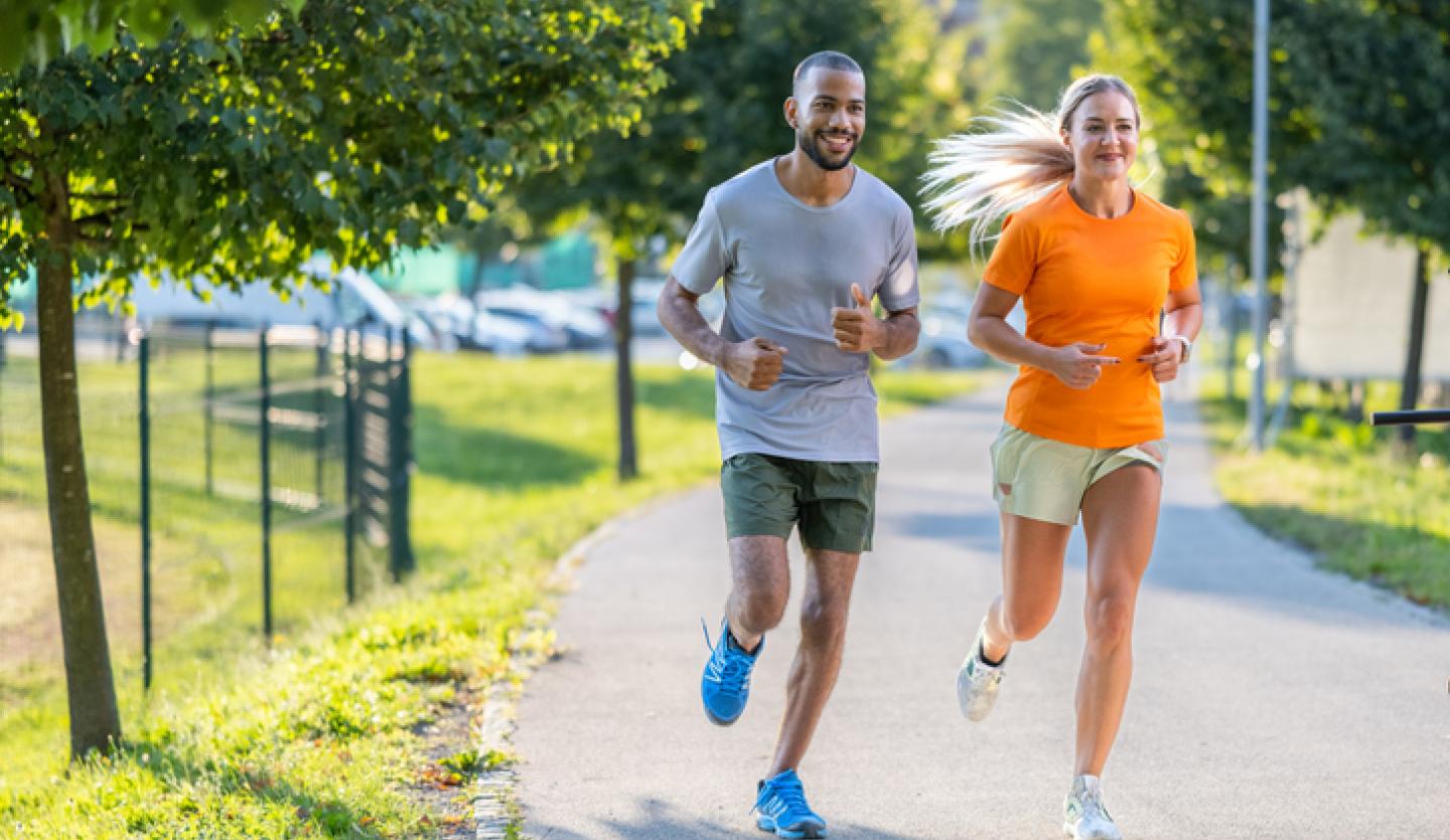 man and woman jogging outside