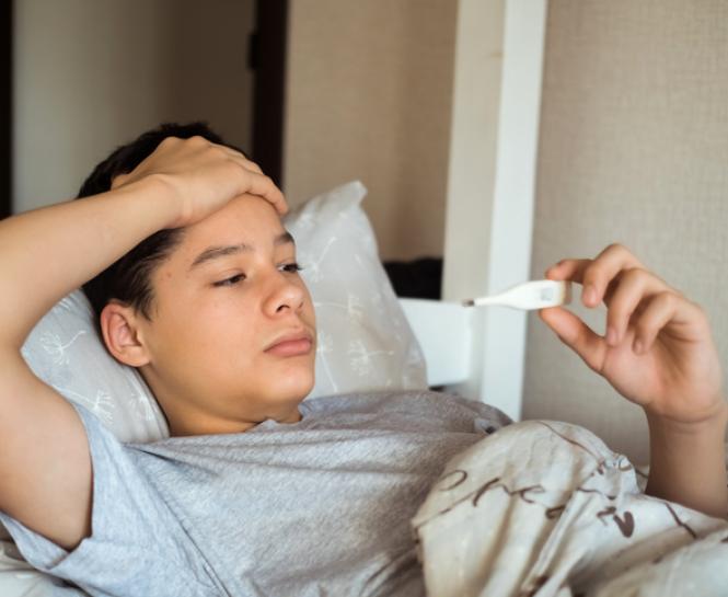 teenager laying down checking temperature