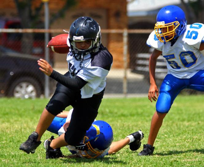 young athletes playing football