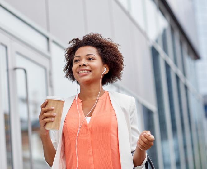 woman walking and holding coffee