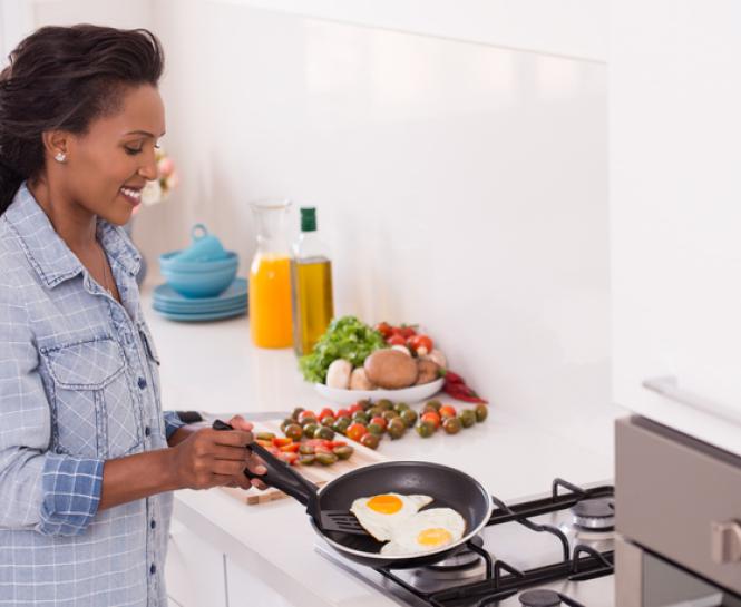 woman cooking eggs