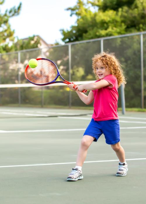 young girl playing tennis