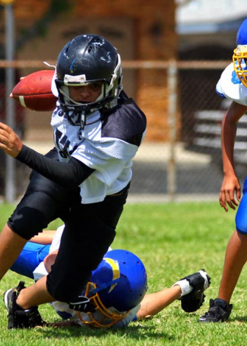 young athletes playing football