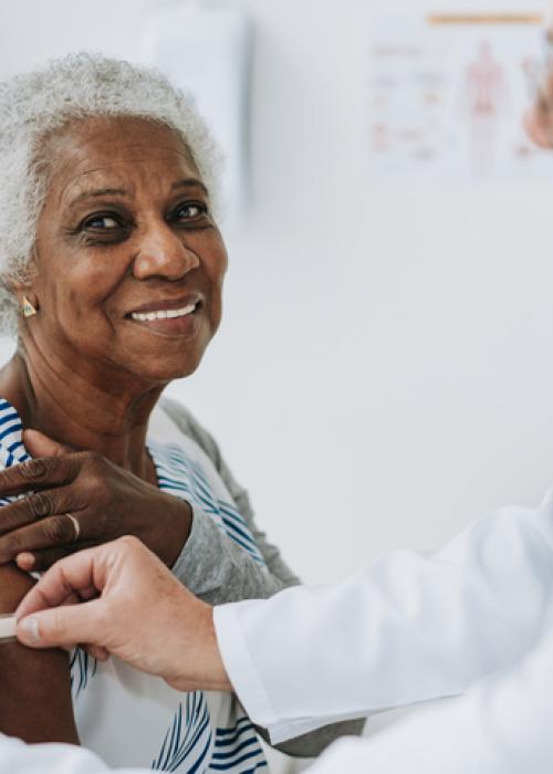 doctor putting band aid on woman