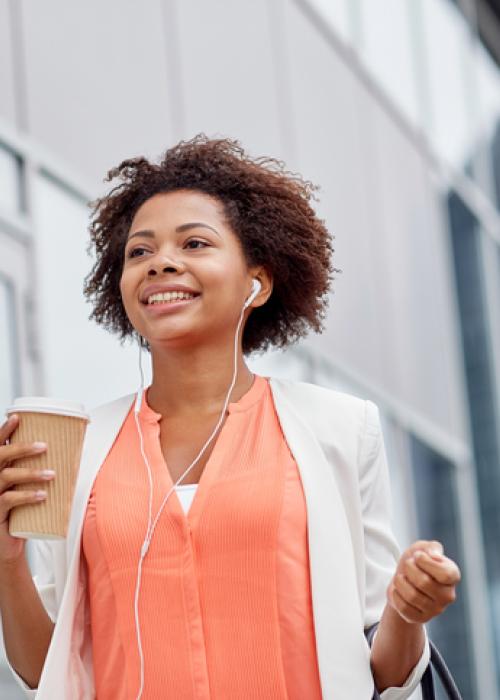 woman walking and holding coffee