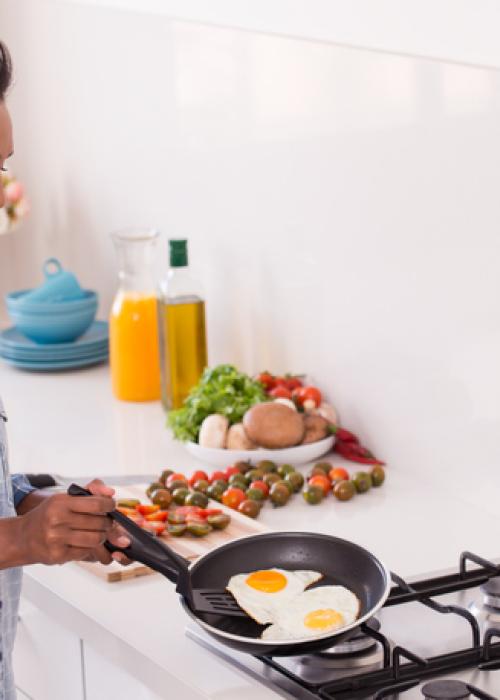 woman cooking eggs