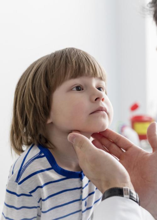 Doctor checking boy's tonsils