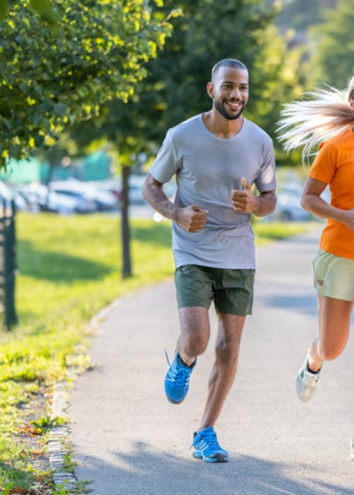 man and woman jogging outside